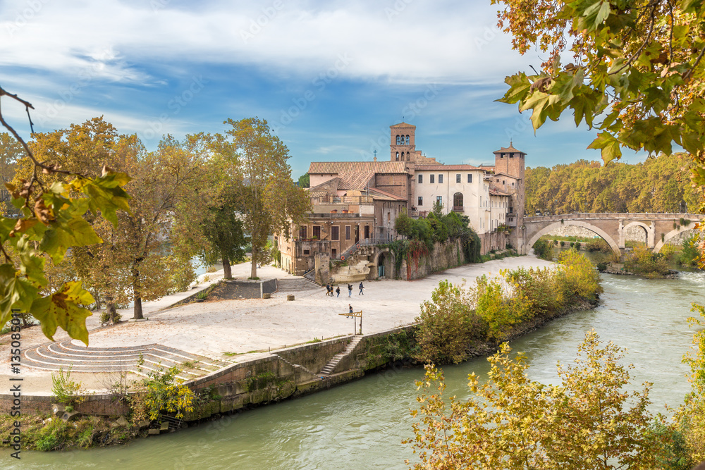 Rome, Italy. Tiberina Island in the Tiber river and the Pons Fabricius is the oldest surviving bridge in Rome. built in 62 BC