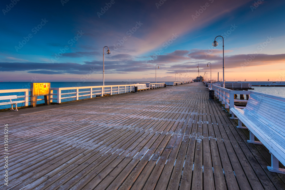 Cold morning, Pier in Sopot at sunrise with amazing colorful sky. Winter in Poland.