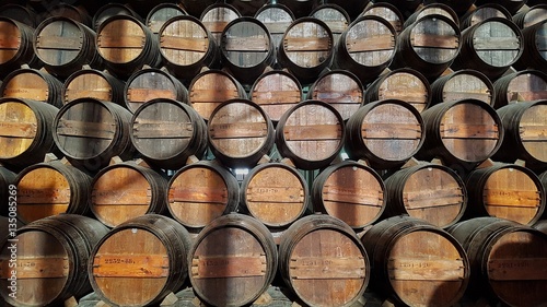 many aging wine barrels aging in line and in top of each other