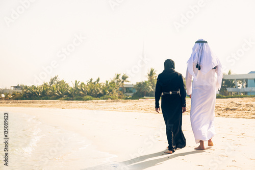 Arabian Couple Walking On The Beach
