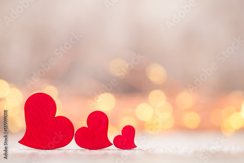 Red hearts on the wooden background.