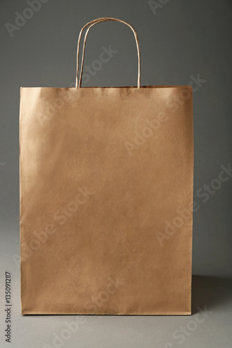 Blank paper bag on grey background