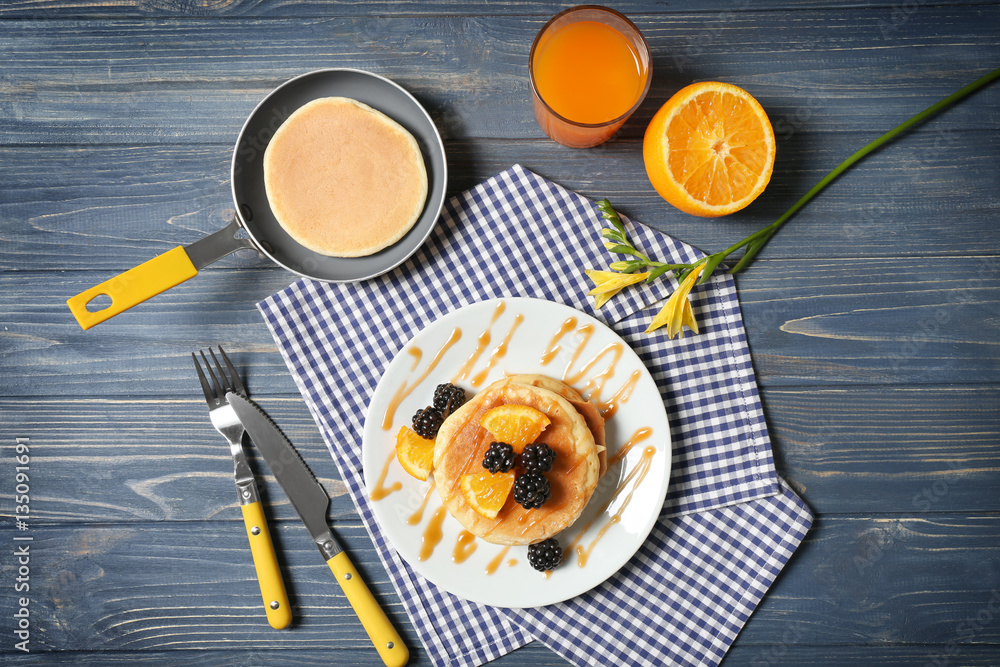 Stack of fresh pancakes with fruits on wooden table Stack of fresh pancakes with fruits on wooden table