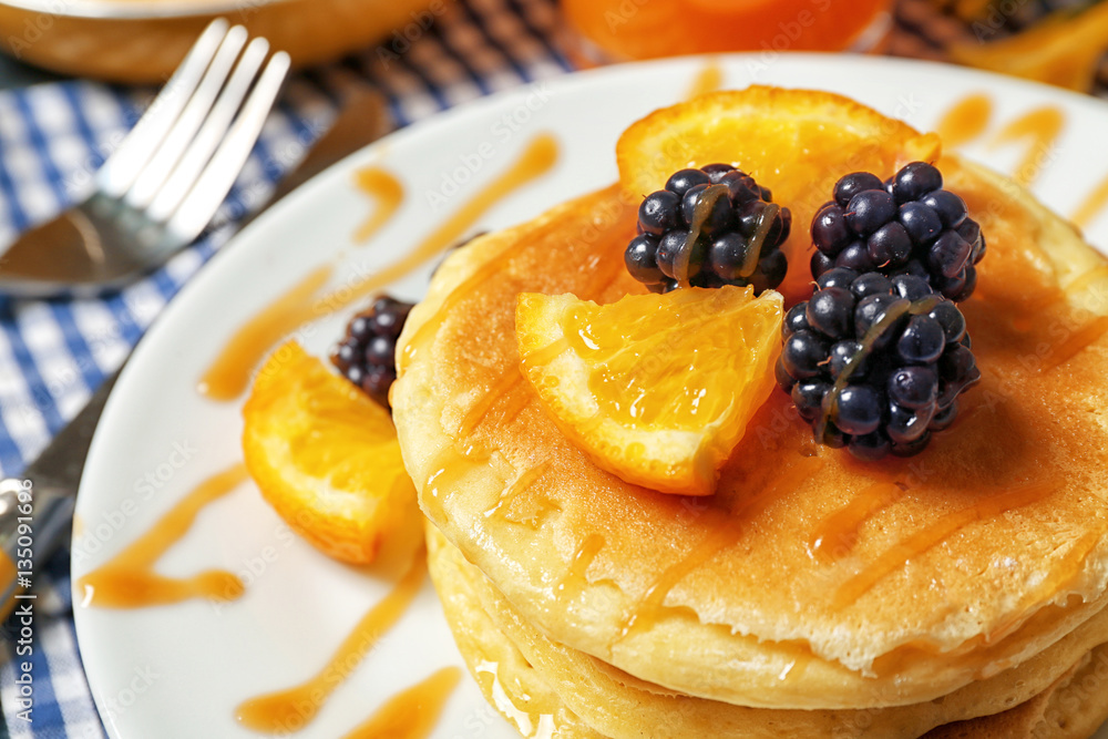 Stack of fresh pancakes with fruits on plate, closeup Stack of fresh pancakes with fruits on plate, closeup