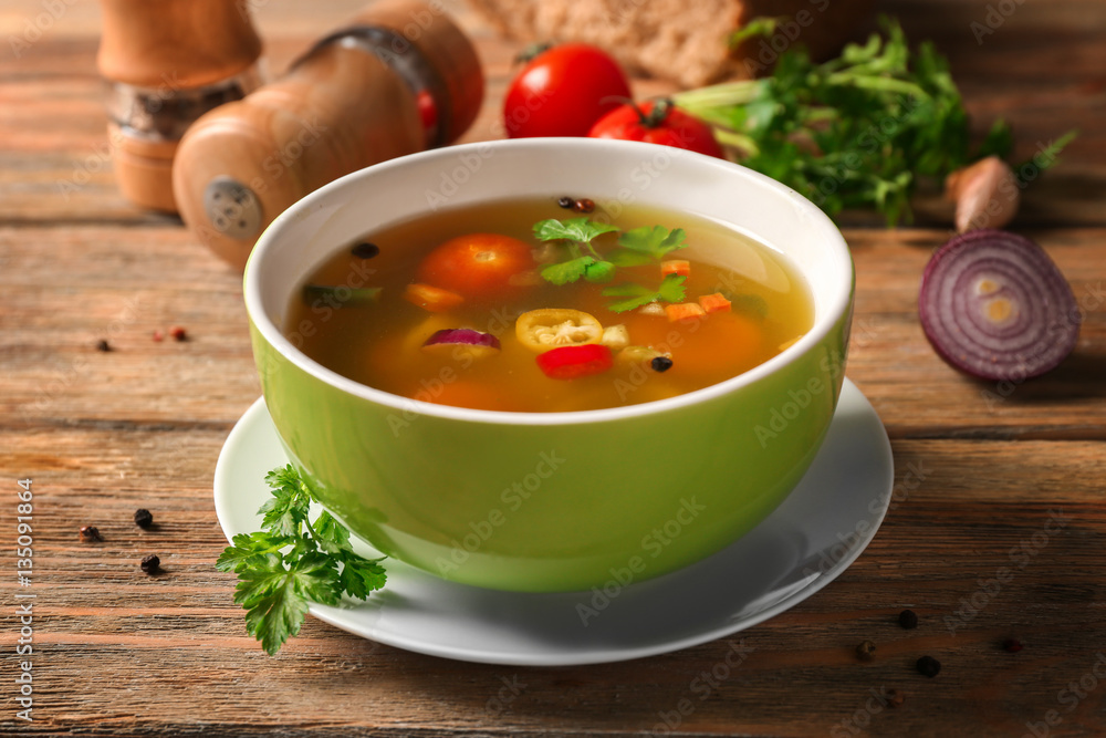 Bowl with fresh vegetable soup on wooden background Bowl with fresh vegetable soup on wooden background