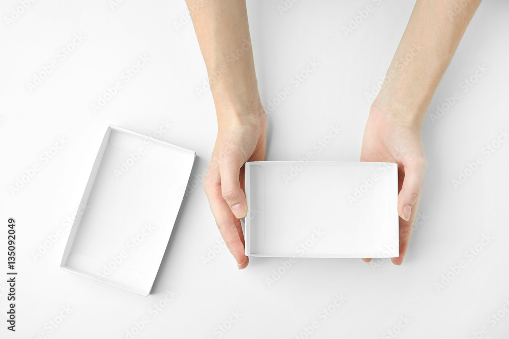 Female hands with open box on white background Female hands with open box on white background