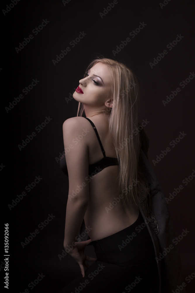 Fashionable young model with bright makeup and in black lingerie