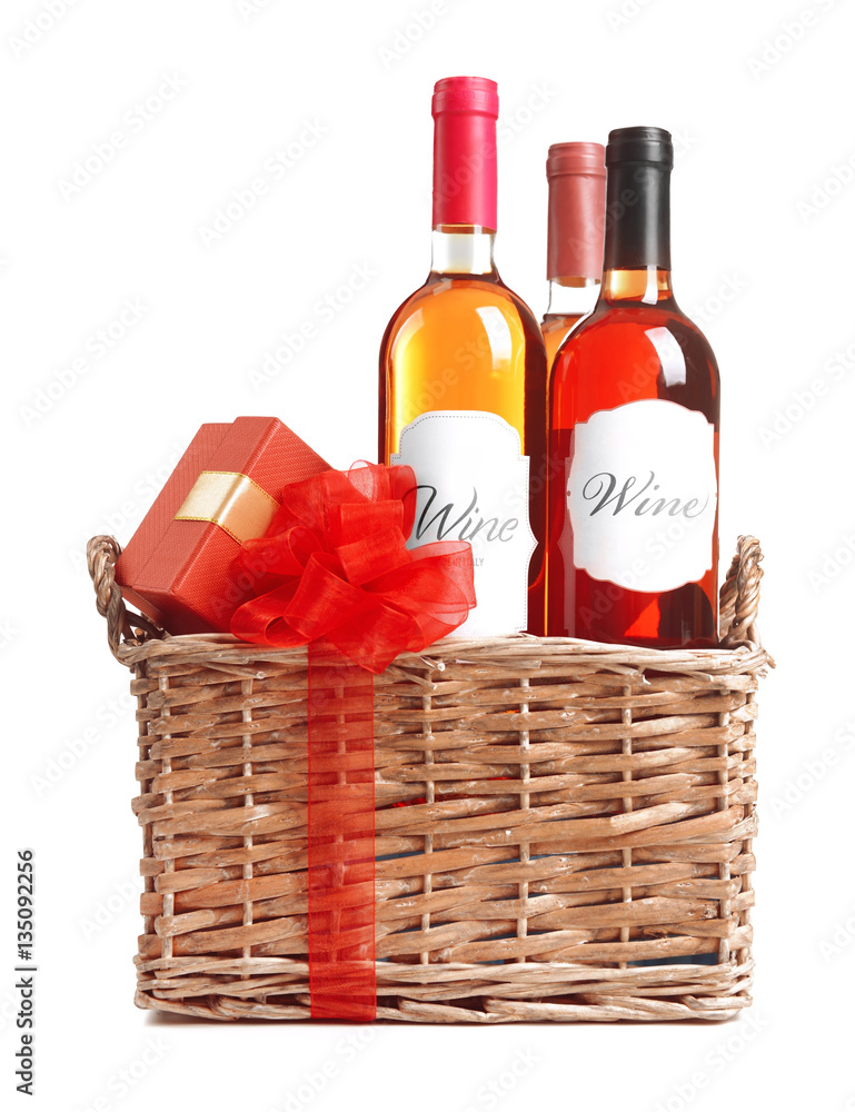 St. Valentines Day concept. Wine bottles and gift box in basket isolated on white St. Valentines Day concept. Wine bottles and gift box in basket isolated on white