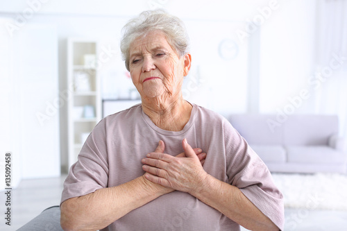 Fotografía Elderly woman having heart attack at home