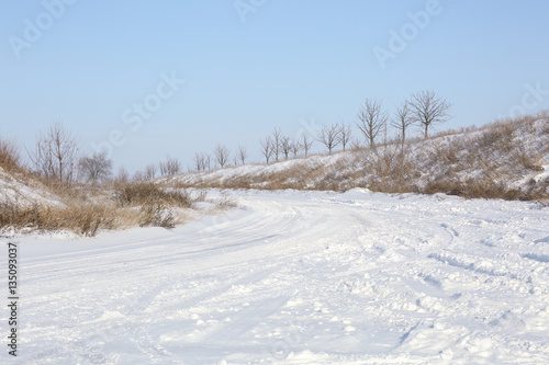 Country side empty road covered with snow on sunny day © Africa Studio
