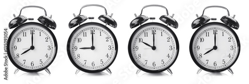 Time change concept. Alarm clocks on white background
