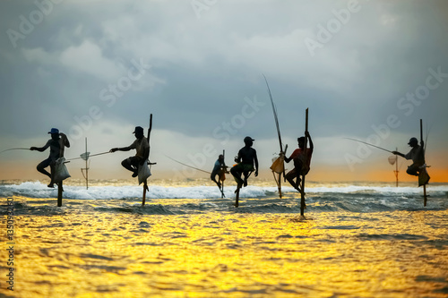 Traditional fishermen on sticks at the sunset in Sri Lanka.