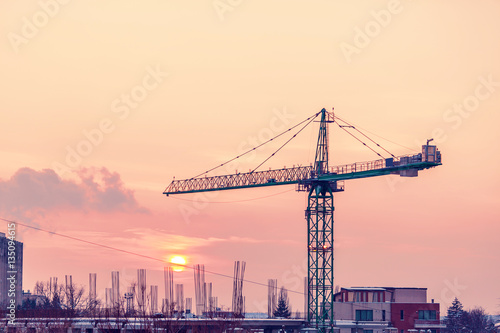 Vibrant sunset in an area of the city with a crane
