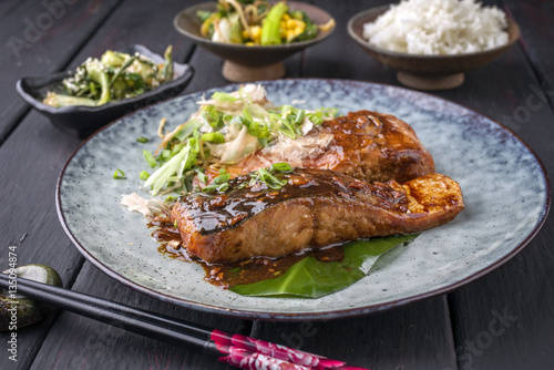 Traditional Japanese Salmon Teriyaki with Vegetable and Rice as close-up on a plate
