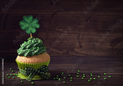 Cupcake with clover cakepick photo