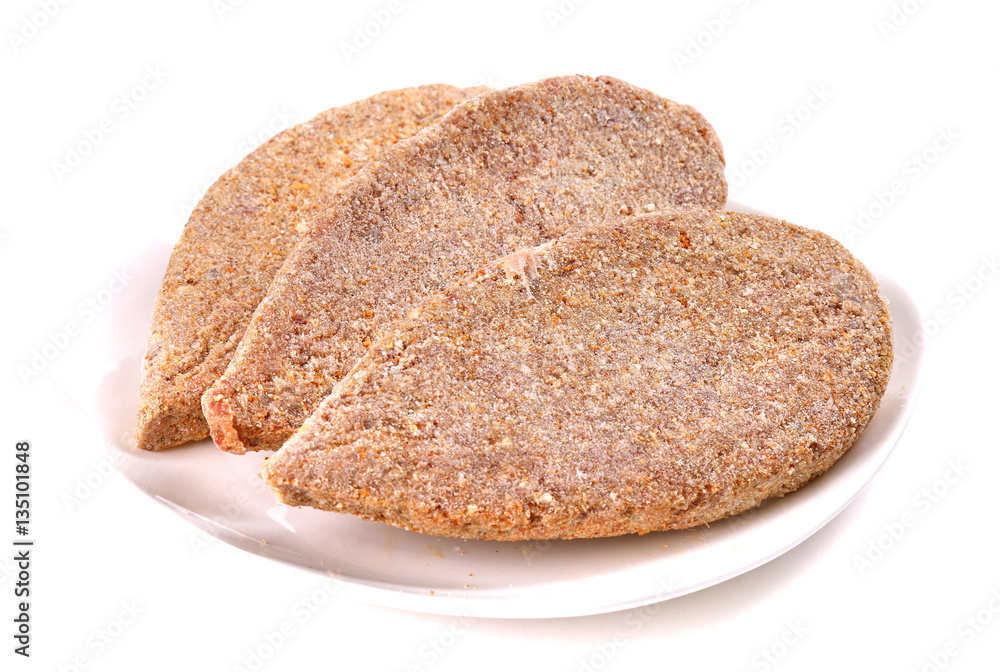Frozen ground meat on a white plate Frozen ground meat on a white plate