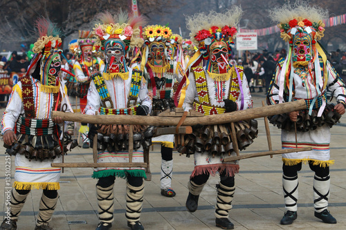 PERNIK, BULGARIA - JANUARY 29, 2017 - Masquerade festival Surva in Pernik, Bulgaria. People with mask called Kukeri dance and perform to scare the evil spirits photo