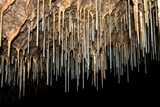 thin stalactites in a cave