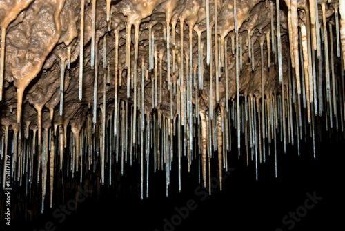 thin stalactites in a cave
