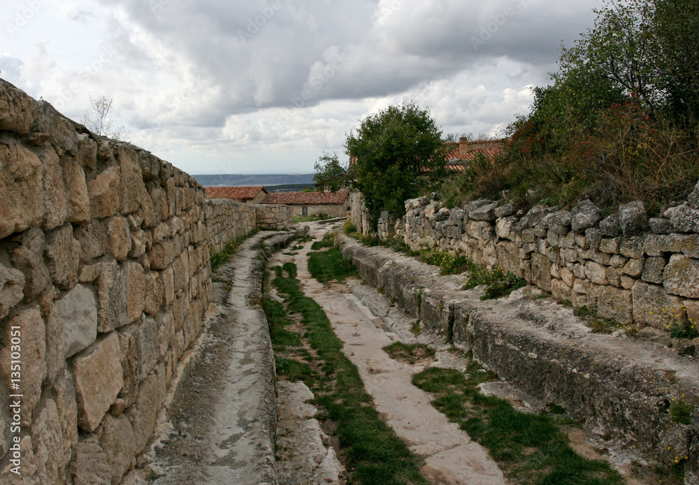 The stony street in the medieval cave city Chufut-Kale near Bakhchisarai, Crimea.