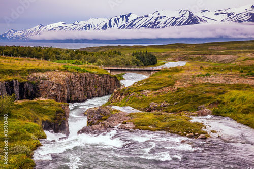 The creek flows among the flat tundra photo
