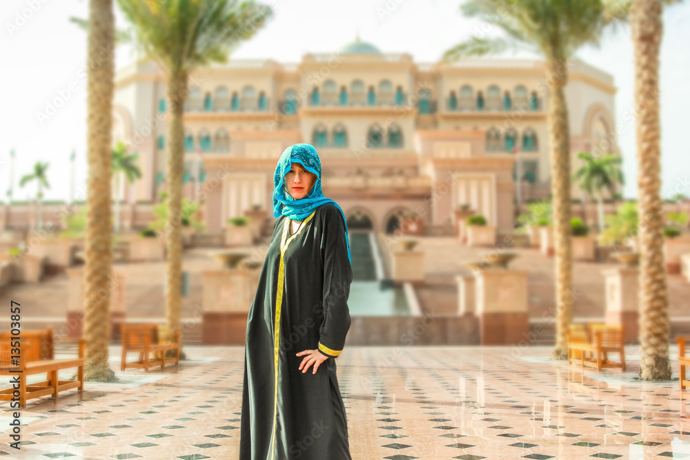 Woman with typical Arab clothes. Luxury vacations and tourism concept. Defocused background at Abu Dhabi, the capital of United Arab Emirates. Holidays, lifestyle and expensive concept. Woman with typical Arab clothes. Luxury vacations and tourism concept. Defocused background at Abu Dhabi, the capital of United Arab Emirates. Holidays, lifestyle and expensive concept.