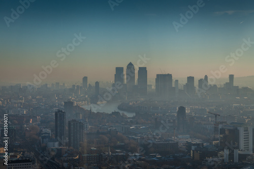 a morning in London with a view of Canary Wharf with smog, air pollution
