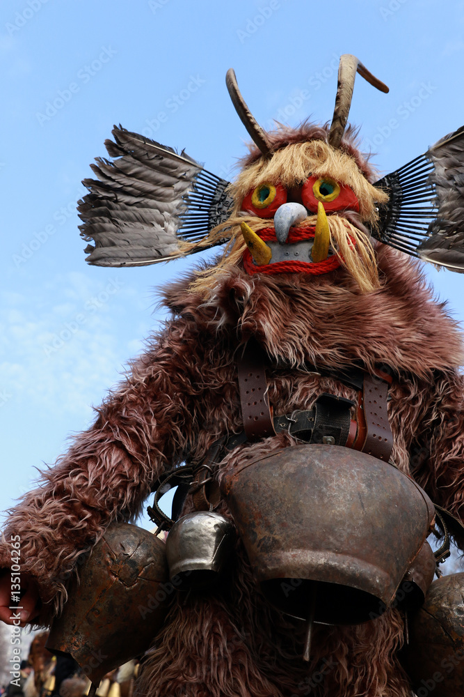Naklejka premium PERNIK, BULGARIA - JANUARY 29, 2017 - Masquerade festival Surva in Pernik, Bulgaria. People with mask called Kukeri dance and perform to scare the evil spirits