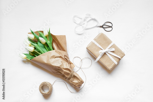 Top view bouquet of white tulips, box gift and accessories