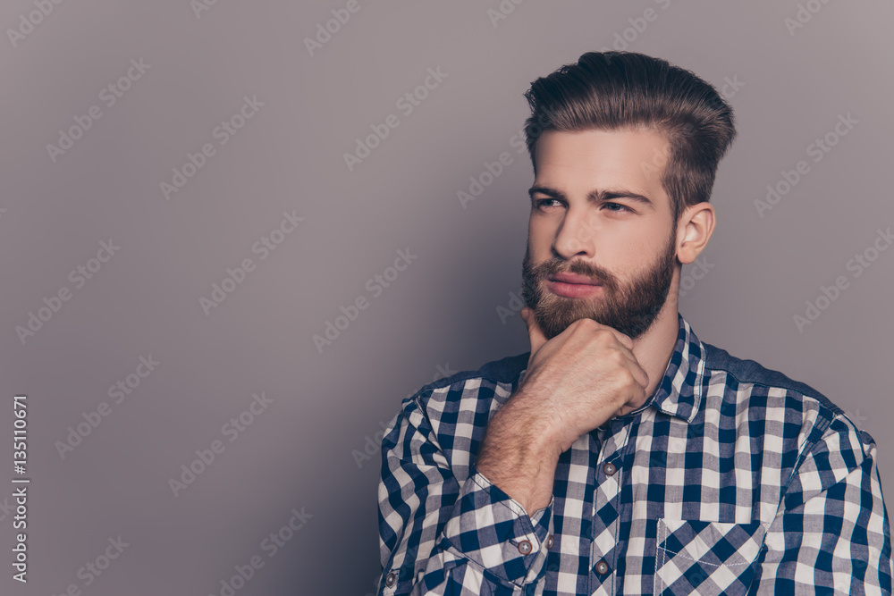 Young handsome thoughtful businessman isolated on gray backgroun