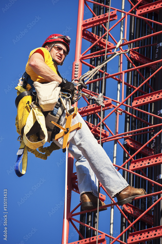 Climber ascending cell tower