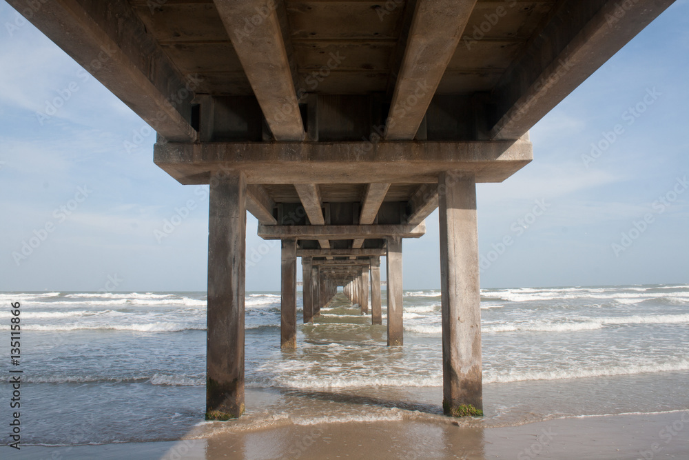 A pier juts into the ocean at the Gulf of Mexico in Texas.