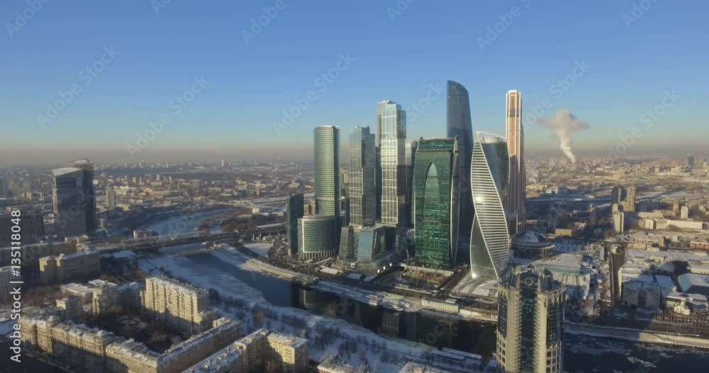Business center Moscow City in the winter day aerial 4k flight around the skyscraper on drones