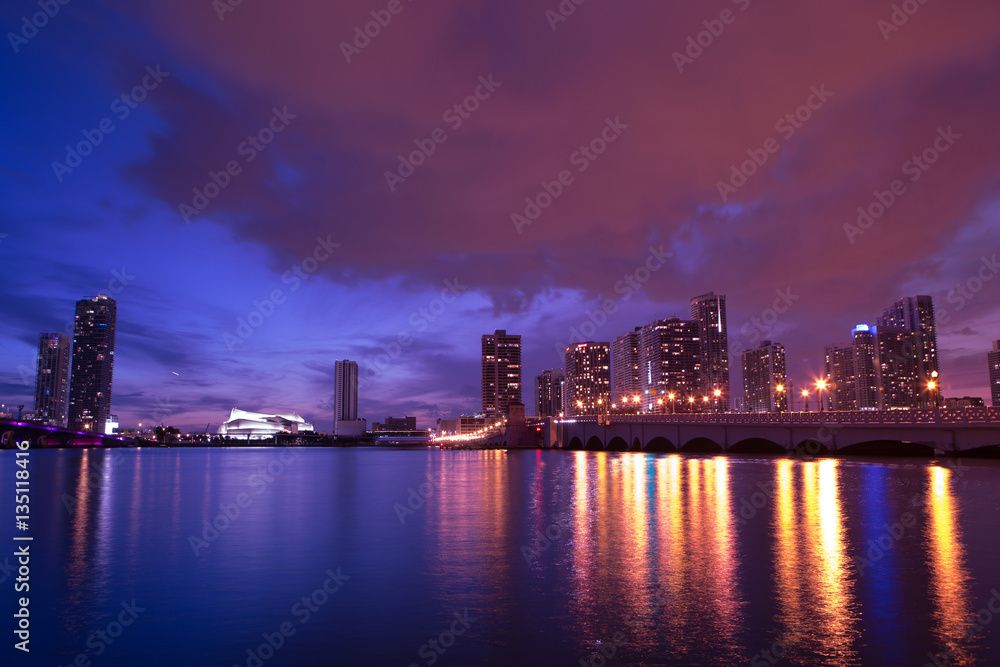 View on Miami Downtown Knight Concert Hall and MacArthur Causeway at night time with a view on a bay, USA