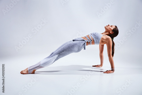Fototapeta Naklejka Na Ścianę i Meble -  Woman doing yoga isolated on white background
