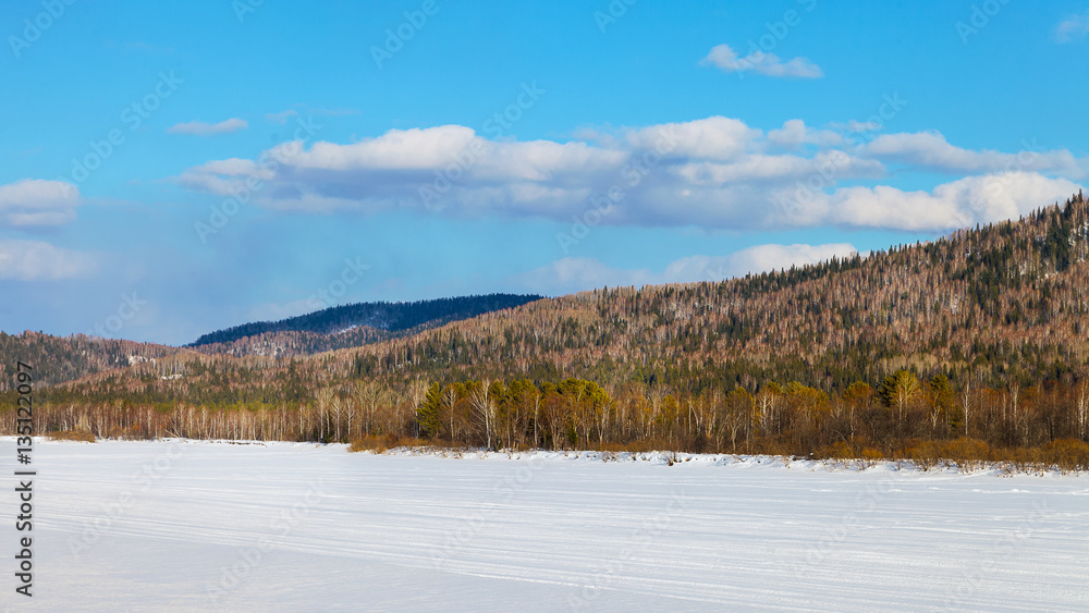 Beautiful landscape with ski run on frozen river
