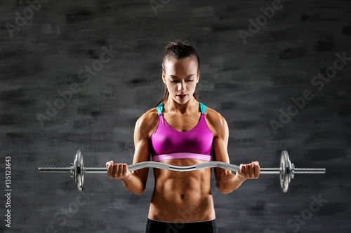 Sporty young woman with bar...