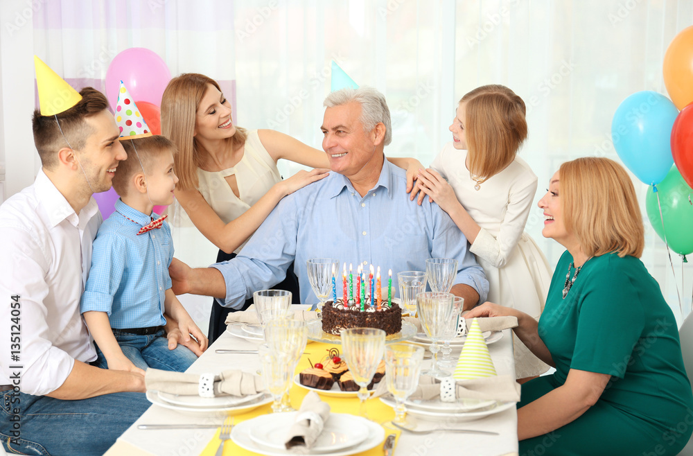 Family celebrating grandfather's birthday together Family celebrating grandfather's birthday together