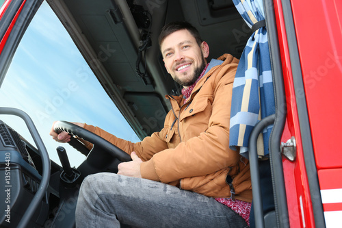 Fototapeta Driver in cabin of big modern truck