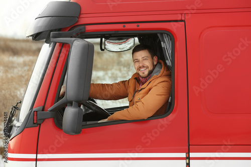 Handsome man driving big modern truck