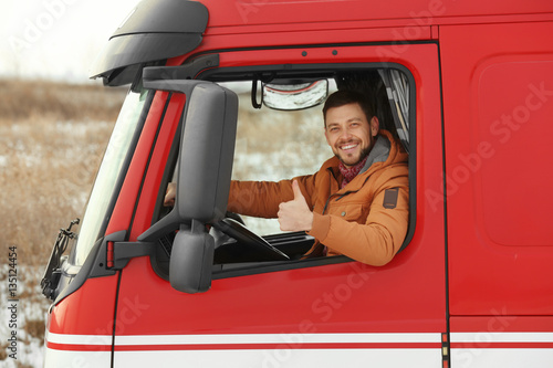 Young man driving big modern truck photo