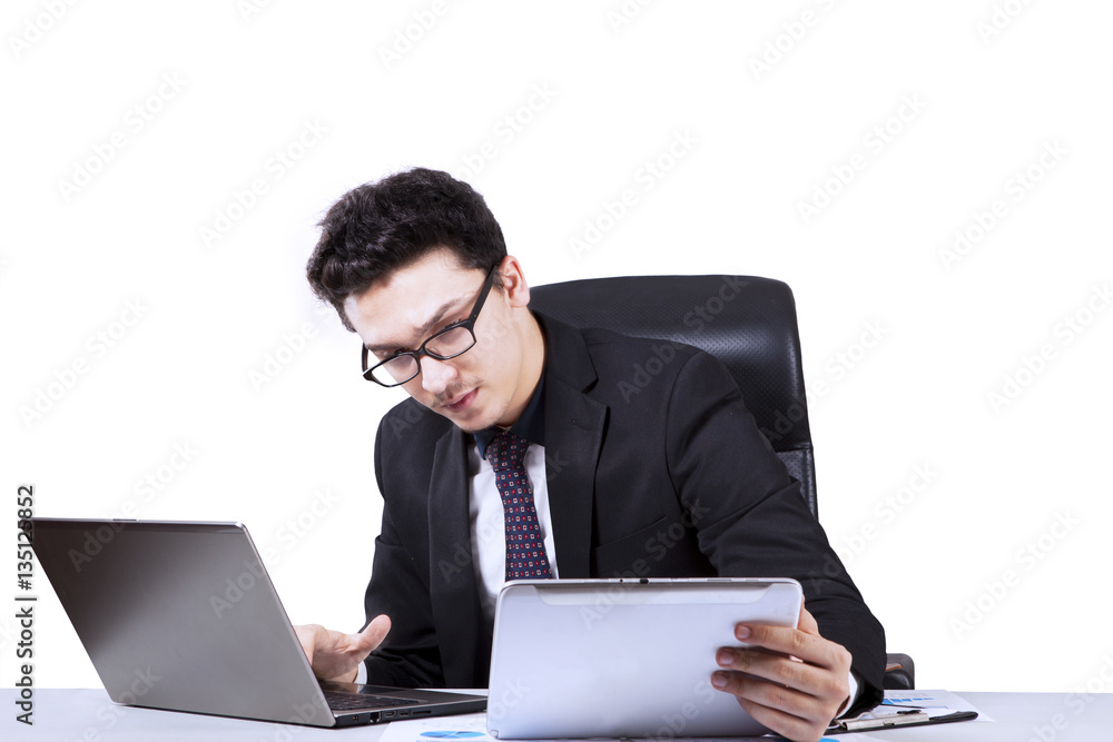 Arabian entrepreneur is using laptop and digital tablet Arabian entrepreneur is using laptop and digital tablet