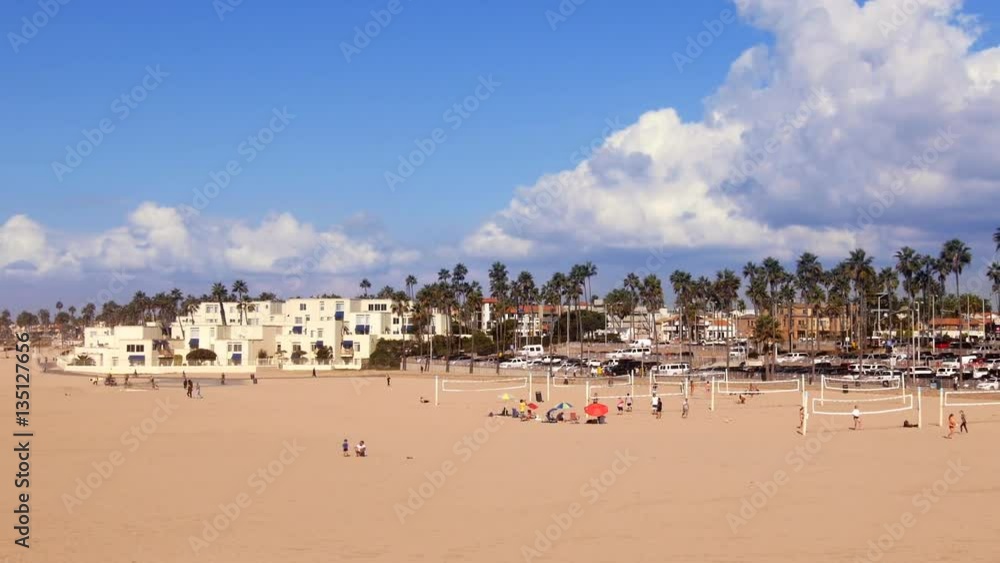 Huntington Beach coastal shoreline shot from the pier shows beachgoers playing volleyball on the free courts. Huntington Beach coastal shoreline shot from the pier shows beachgoers playing volleyball on the free courts.