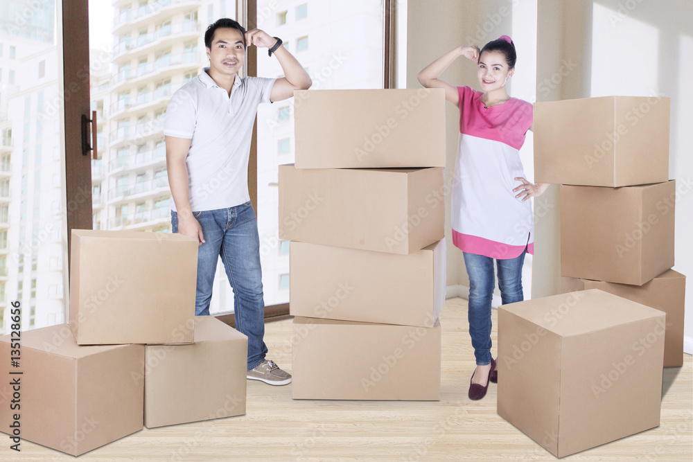 Husband and wife standing with boxes Husband and wife standing with boxes