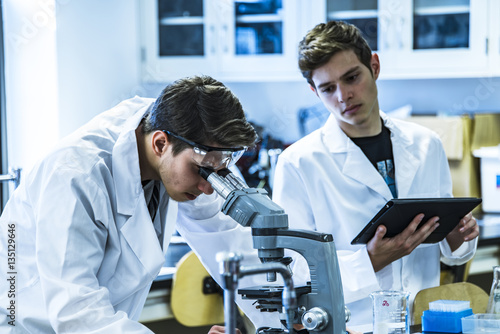 Coronavirus. Two young male scientist working on science research in laboratory. lab reserach of two man. Laboratory researchers