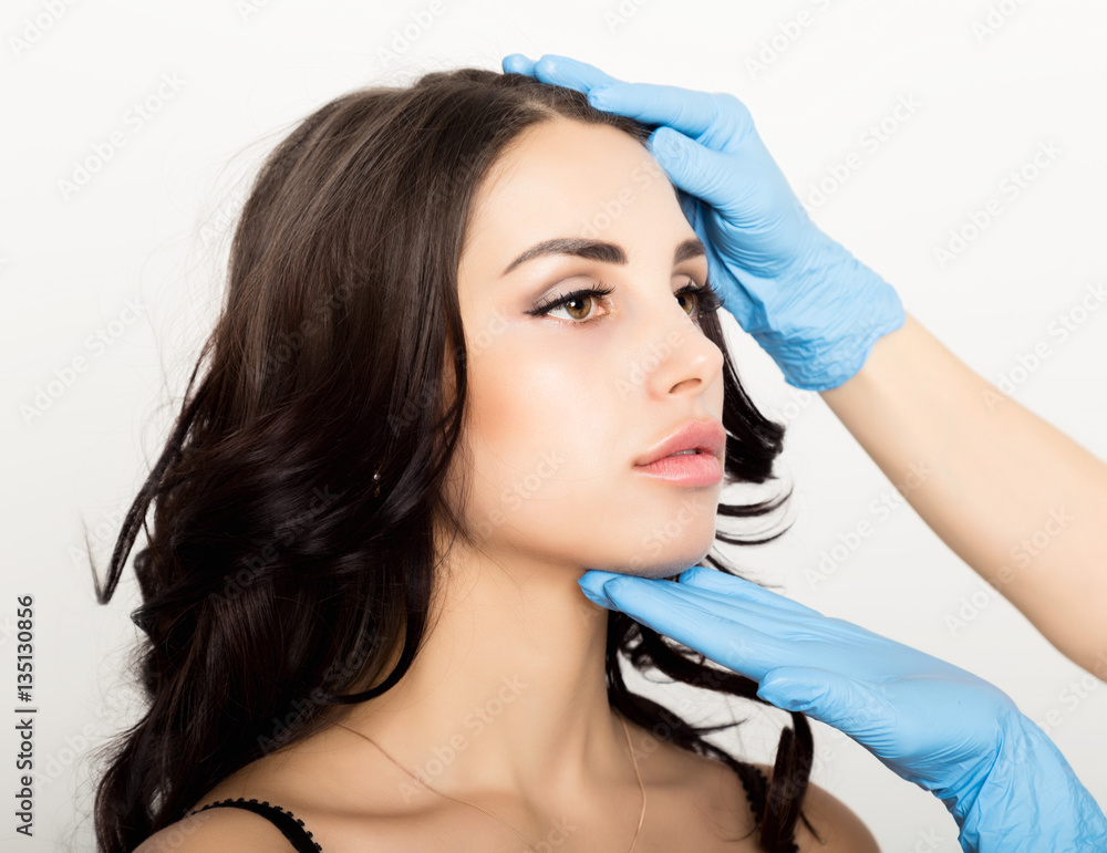 Fototapeta premium Closeup of Beautiful young woman gets injection in eye and lips area from beautician. cosmetology concept
