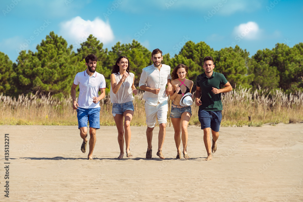 Group of friends together on the beach having fun.