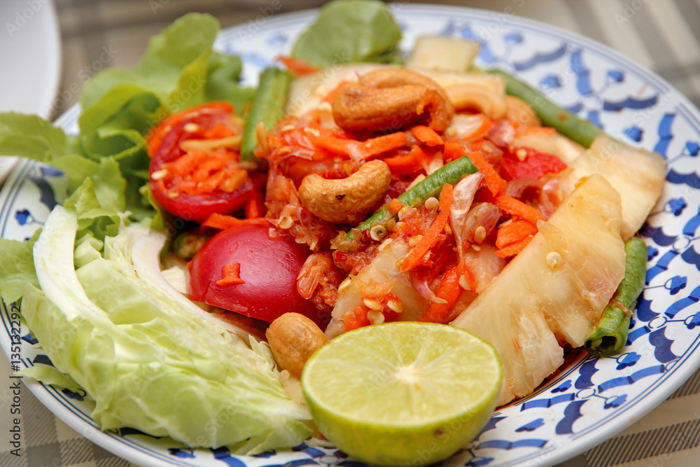 Spicy and sour vegetable salad with pineapple .