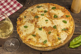 Homemade Margherita pizza on dark wooden table