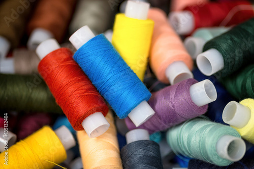 Many colorful reels of threads for embroidery. Macro background.